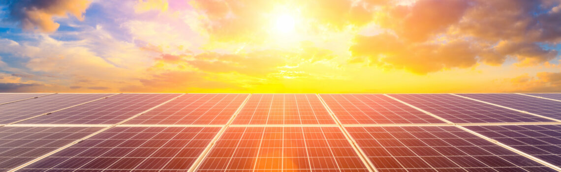 Photovoltaic solar panels on sunset sky background,green clean energy concept.